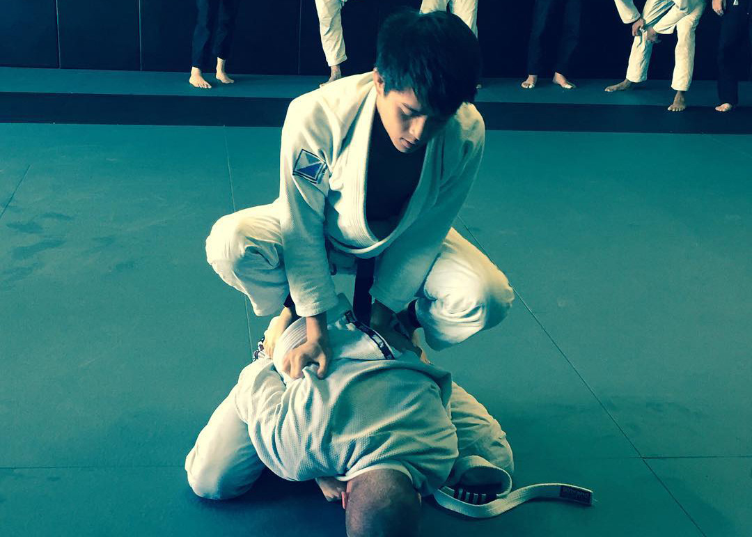 students rolling during a belt grading